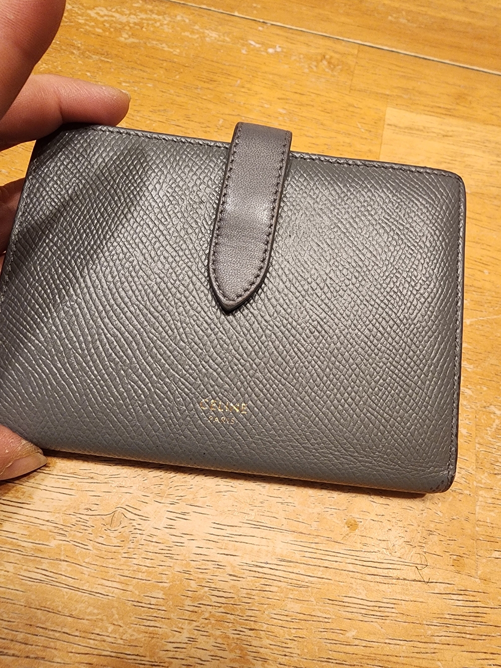 Celine Grained Calfskin Medium Strap Wallet in the color Pebble.